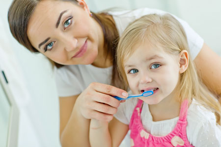 Mom and Daughter brushing their teeth - Pediatric Dentist & Breastfeeding expert in Albany, NY
