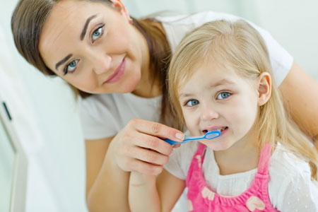 Mom and Daughter brushing their teeth - Pediatric Dentist & Breastfeeding expert in Albany, NY